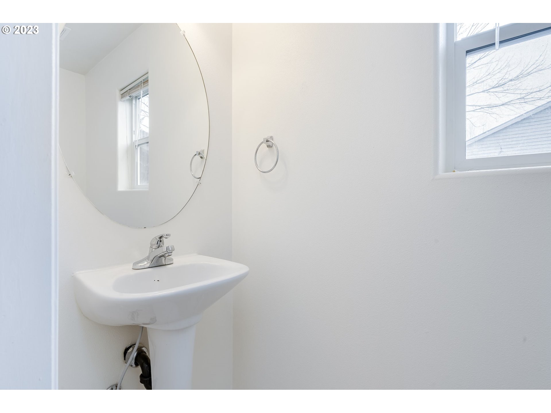 713 Northeast Mariners Loop Portland, OR 97211 - Photo 21 of 40 a bathroom with a sink a mirror and window