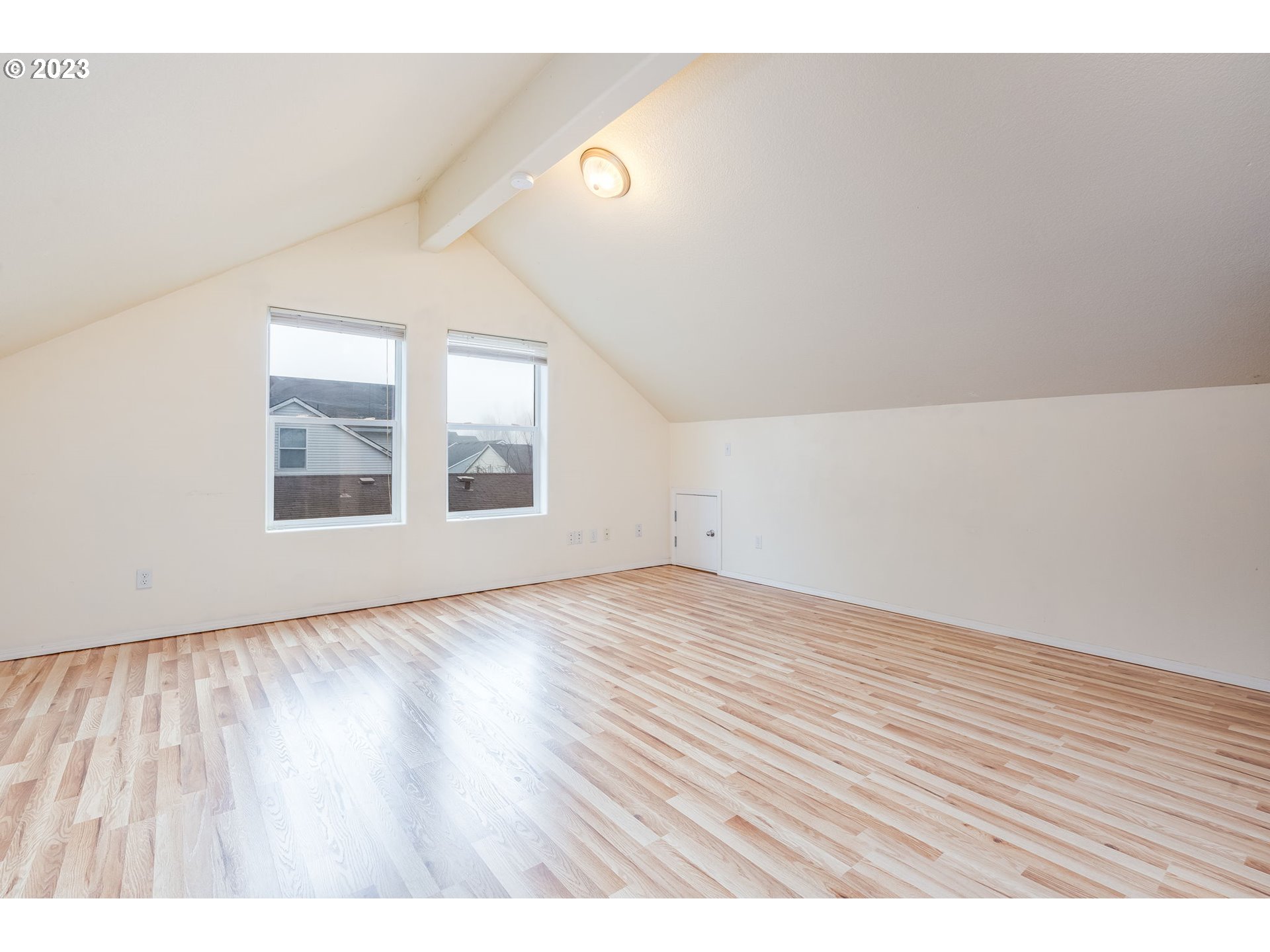 713 Northeast Mariners Loop Portland, OR 97211 - Photo 24 of 40 a view of an empty room with wooden floor and a window