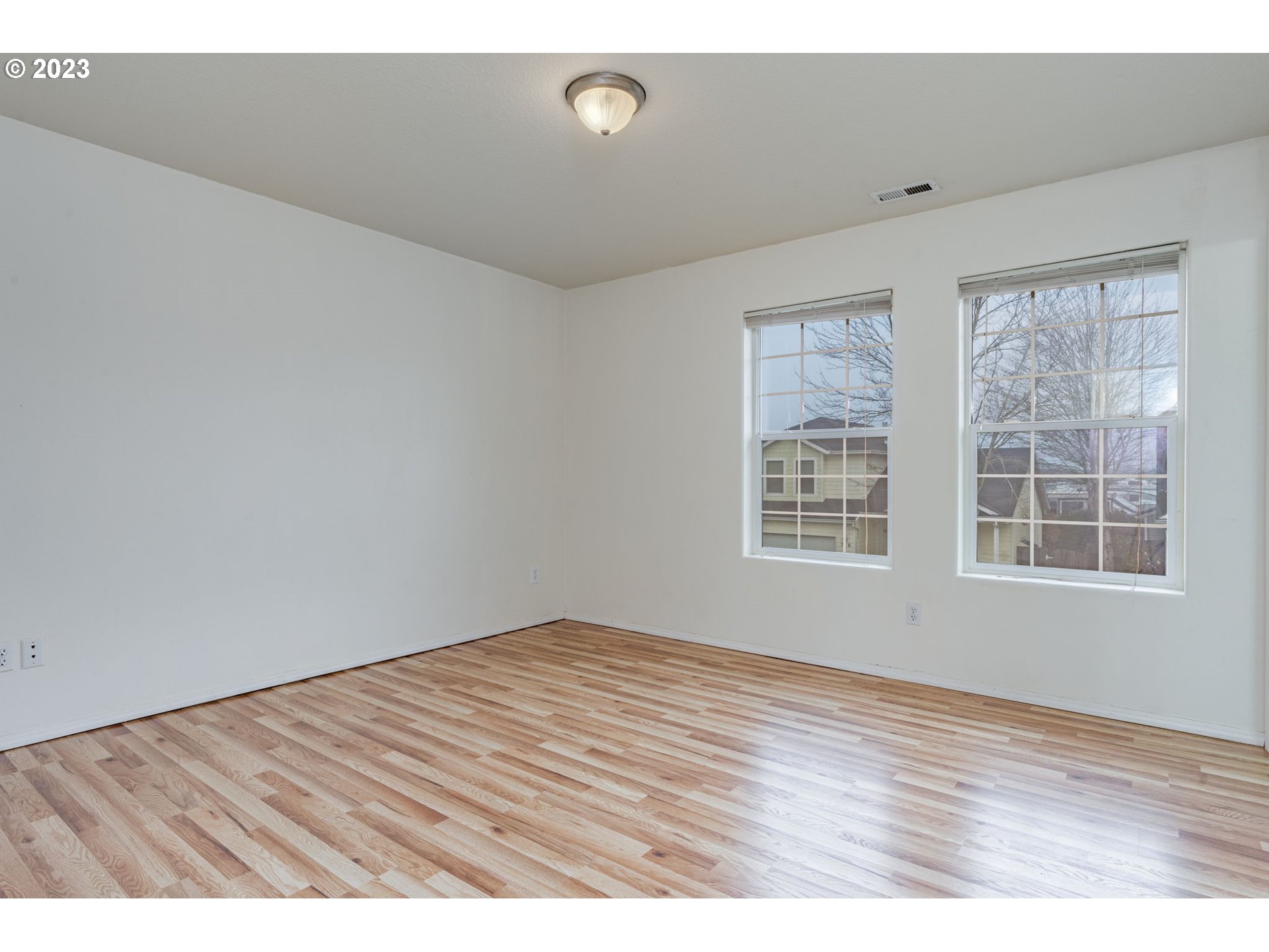 713 Northeast Mariners Loop Portland, OR 97211 - Photo 25 of 40 a view of an empty room with wooden floor and a window