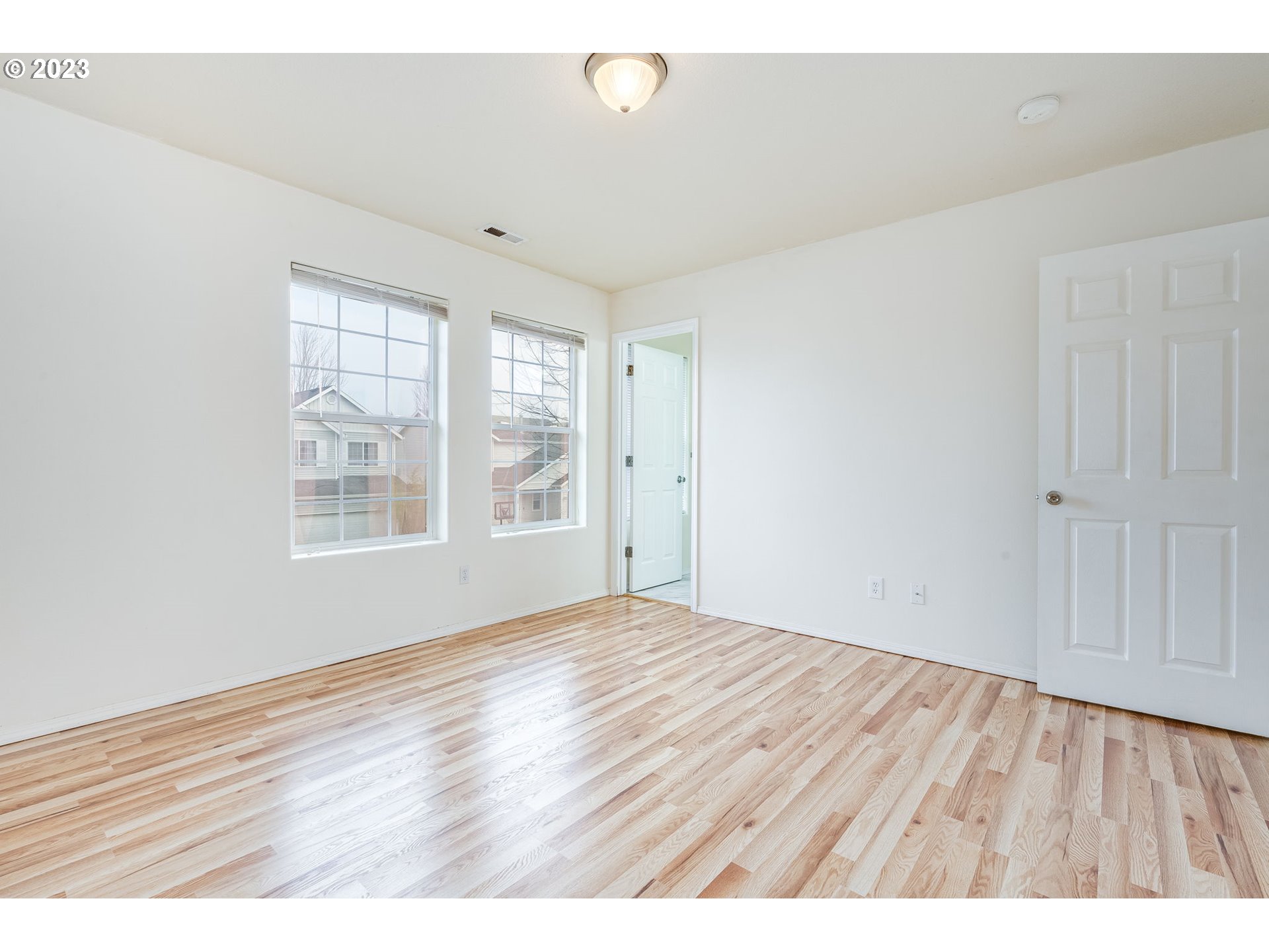 713 Northeast Mariners Loop Portland, OR 97211 - Photo 26 of 40 a view of an empty room with wooden floor and a window