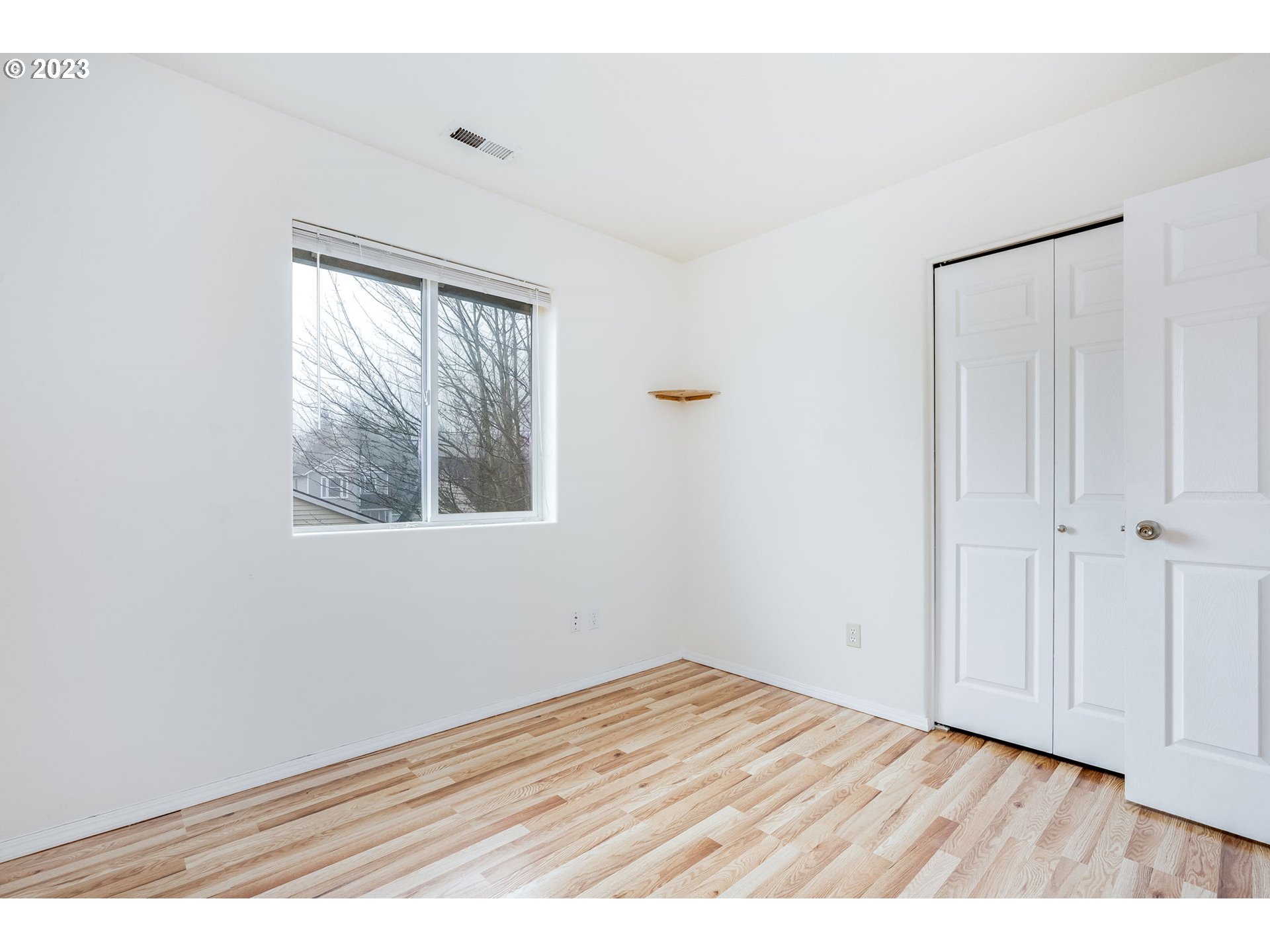 713 Northeast Mariners Loop Portland, OR 97211 - Photo 29 of 40 a view of an empty room with wooden floor and a window