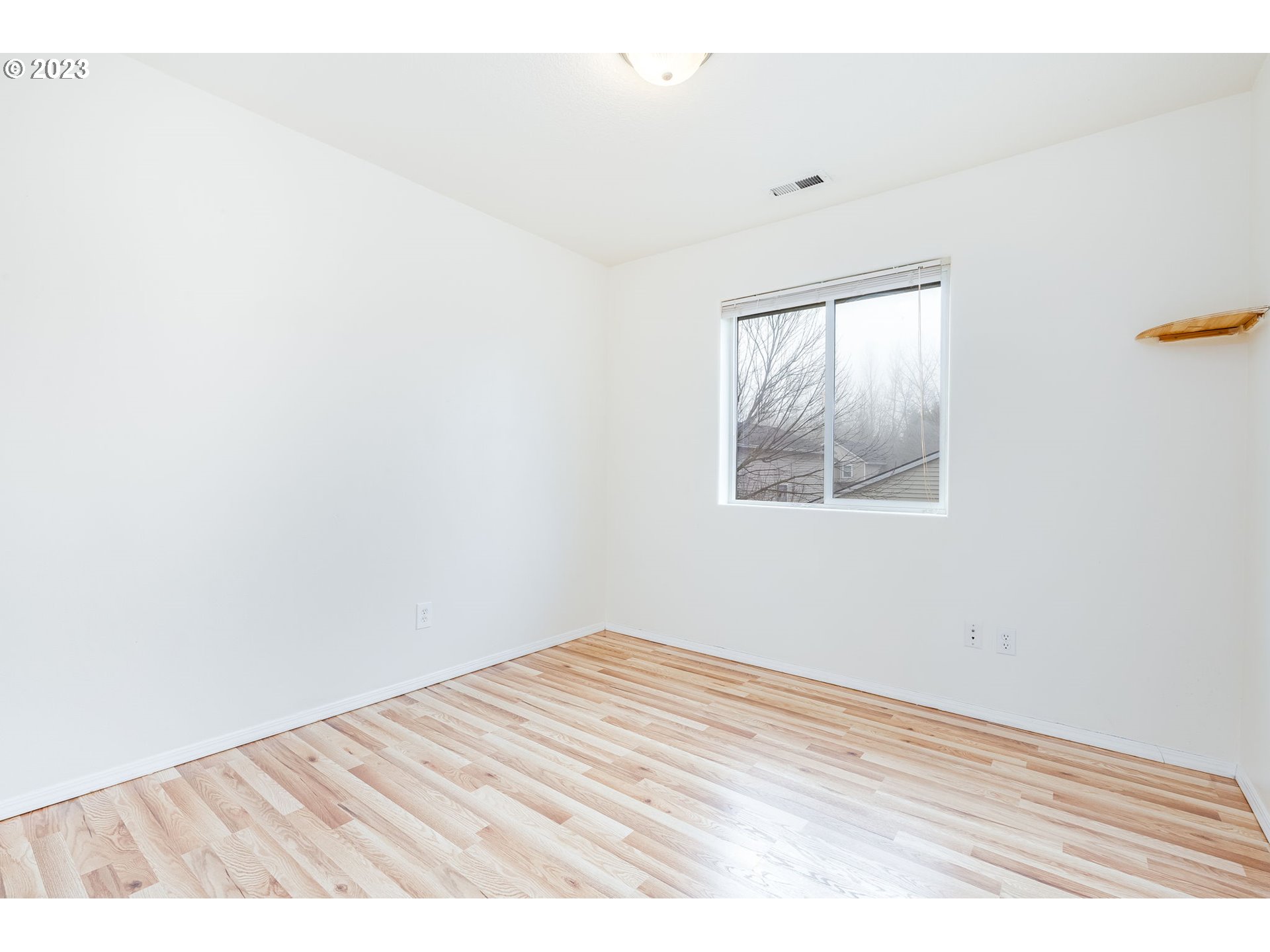 713 Northeast Mariners Loop Portland, OR 97211 - Photo 30 of 40 an empty room with wooden floor and windows