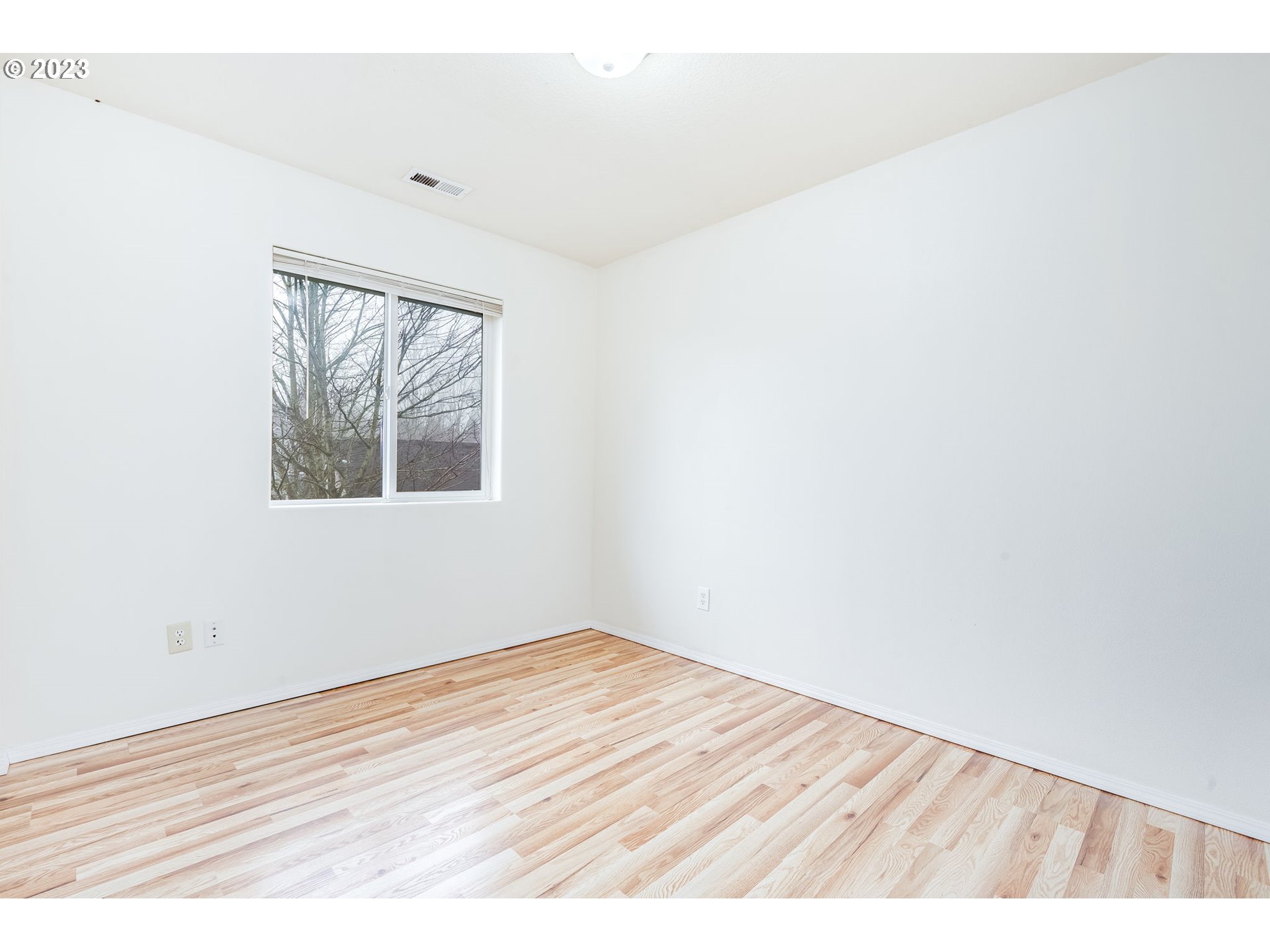 713 Northeast Mariners Loop Portland, OR 97211 - Photo 32 of 40 an empty room with wooden floor and windows