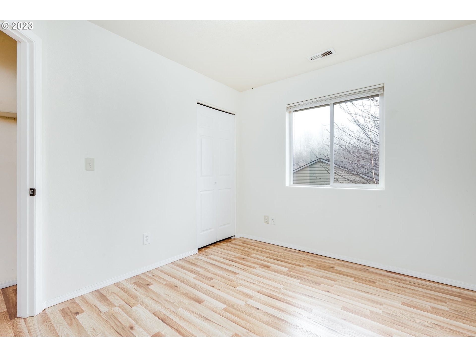 713 Northeast Mariners Loop Portland, OR 97211 - Photo 33 of 40 an empty room with wooden floor and windows