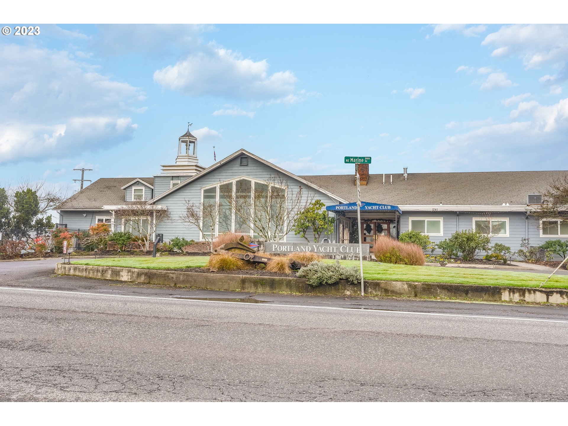713 Northeast Mariners Loop Portland, OR 97211 - Photo 39 of 40 a view of a big house with a big yard and large trees