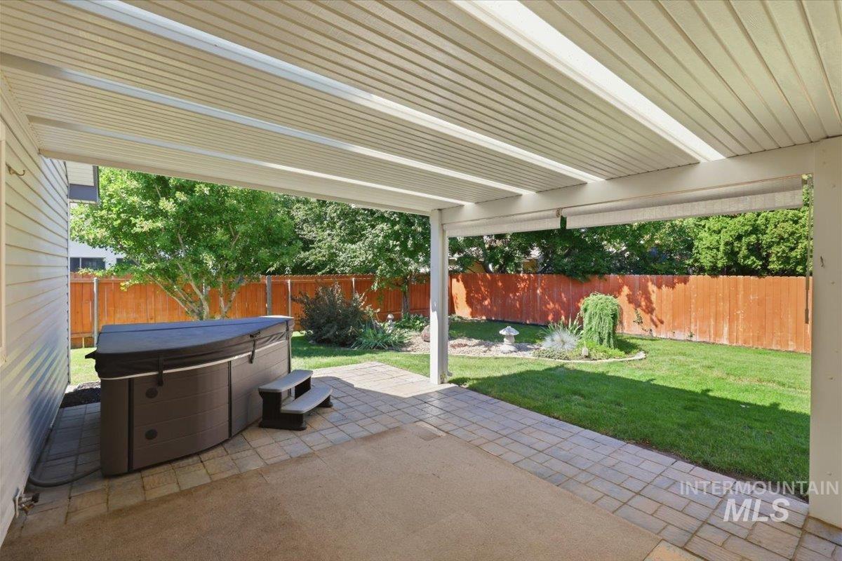 2075 North Springland Place Boise, ID 83713 - Photo 37 of 49 Covered patio area featuring a hot tub with steps, a paved section, and a concrete slab