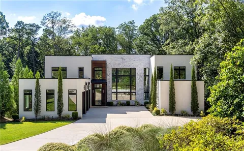 a living room with furniture windows and a flat screen tv