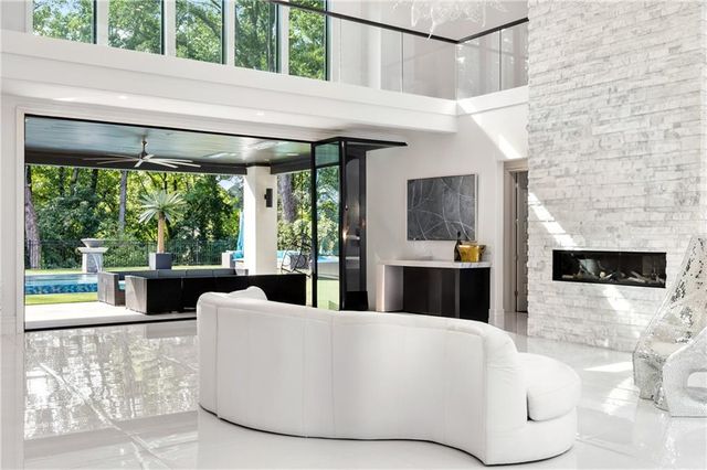 a kitchen with stainless steel appliances kitchen island granite countertop a table and chairs