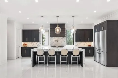 a view of a dining room with furniture and chandelier