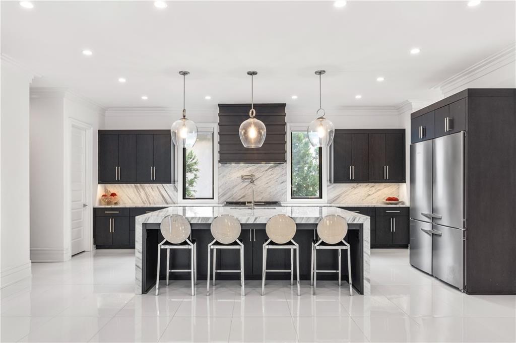 1105 Moores Mill Road Northwest Atlanta, GA 30327 - Photo 22 of 77 a large kitchen with a table and chairs