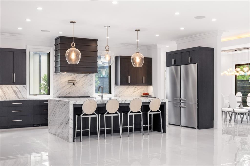 1105 Moores Mill Road Northwest Atlanta, GA 30327 - Photo 23 of 77 a kitchen with stainless steel appliances kitchen island granite countertop a table and chairs