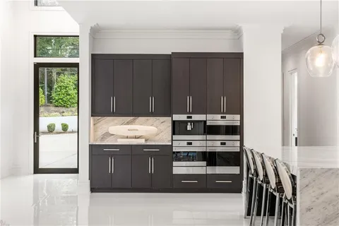 a view of a hallway with wooden floor and windows