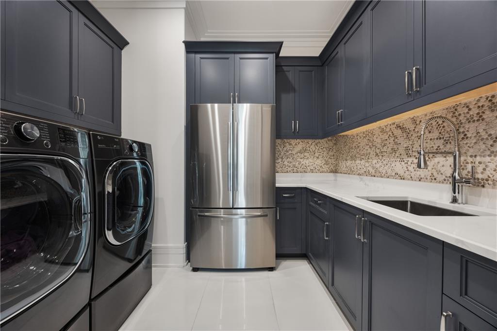 1105 Moores Mill Road Northwest Atlanta, GA 30327 - Photo 31 of 77 a kitchen with a refrigerator and a sink