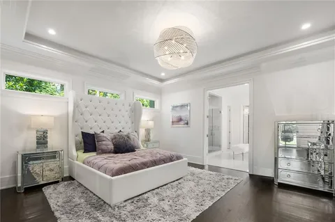 a bedroom with a bed and a chandelier