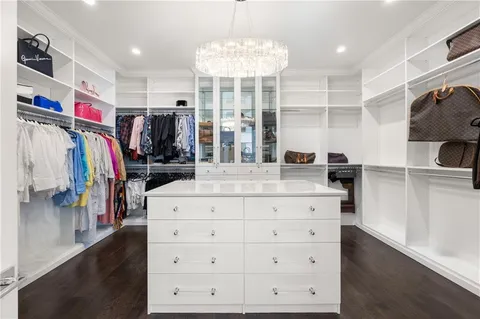 a living room with furniture a flat screen tv and a table