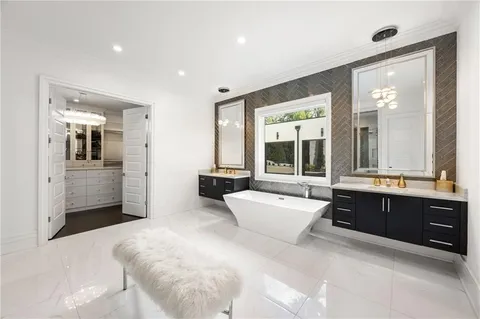 a kitchen with stainless steel appliances kitchen island granite countertop a table chairs and a refrigerator