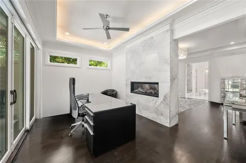a bedroom with a large bed and wooden floor