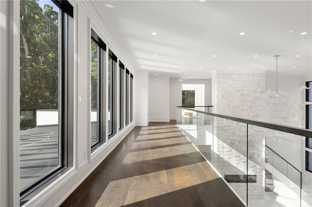 1105 Moores Mill Road Northwest Atlanta, GA 30327 - Photo 43 of 77 a view of a hallway with wooden floor and windows