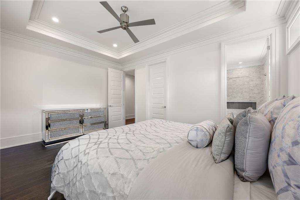 1105 Moores Mill Road Northwest Atlanta, GA 30327 - Photo 48 of 77 a bedroom with a bed and a chandelier