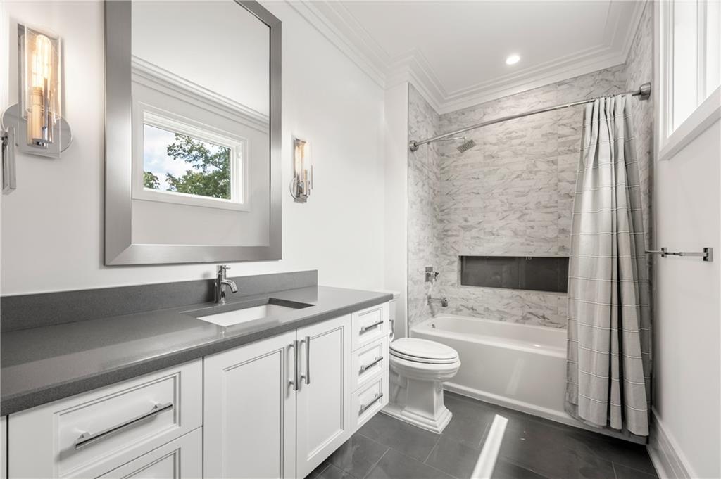 1105 Moores Mill Road Northwest Atlanta, GA 30327 - Photo 49 of 77 a bathroom with a sink a toilet and a bathtub