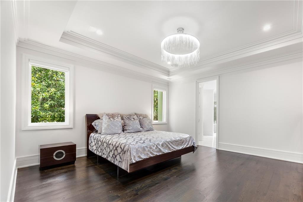 1105 Moores Mill Road Northwest Atlanta, GA 30327 - Photo 51 of 77 a bedroom with a bed and a chandelier