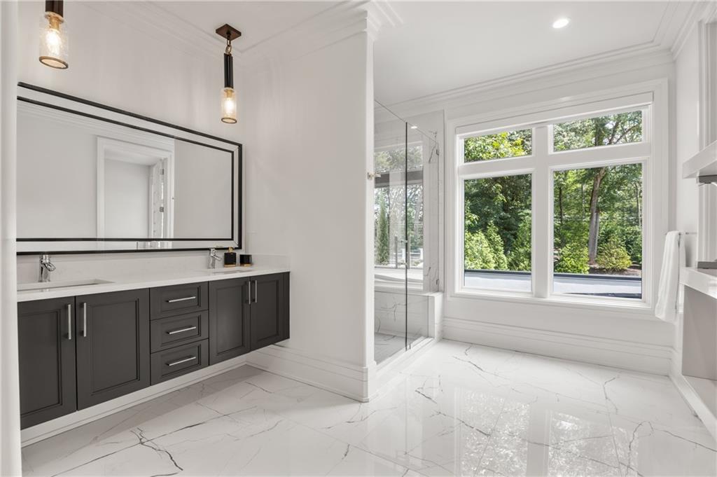 1105 Moores Mill Road Northwest Atlanta, GA 30327 - Photo 52 of 77 a spacious bathroom with a vanity mirror and a bathtub