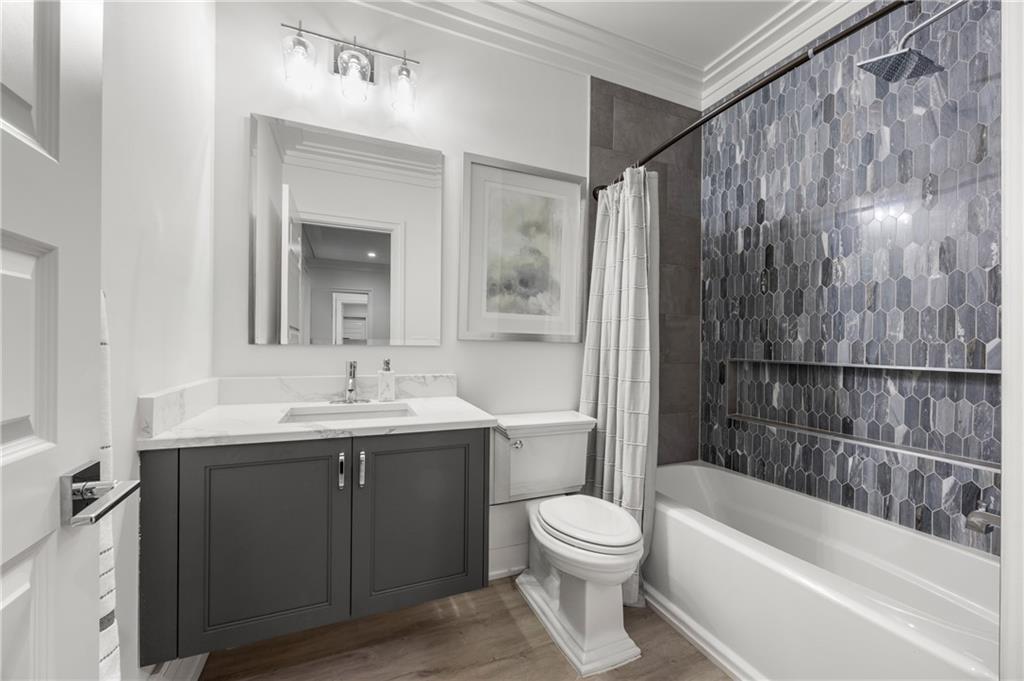 1105 Moores Mill Road Northwest Atlanta, GA 30327 - Photo 55 of 77 a bathroom with a sink a toilet and shower