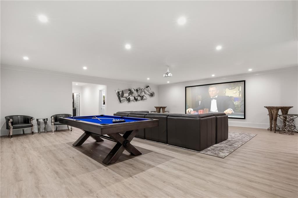 1105 Moores Mill Road Northwest Atlanta, GA 30327 - Photo 57 of 77 a living room with furniture a flat screen tv and a table