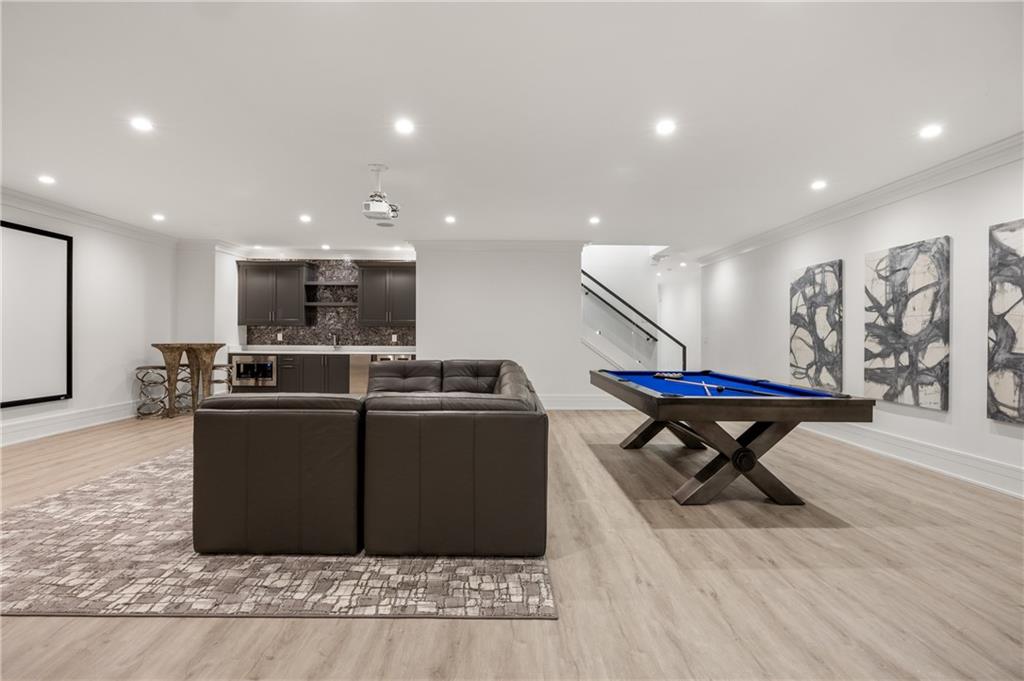 1105 Moores Mill Road Northwest Atlanta, GA 30327 - Photo 58 of 77 a kitchen with stainless steel appliances kitchen island granite countertop a table chairs and a refrigerator