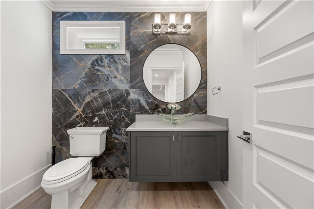 1105 Moores Mill Road Northwest Atlanta, GA 30327 - Photo 61 of 77 a bathroom with a toilet sink vanity and mirror