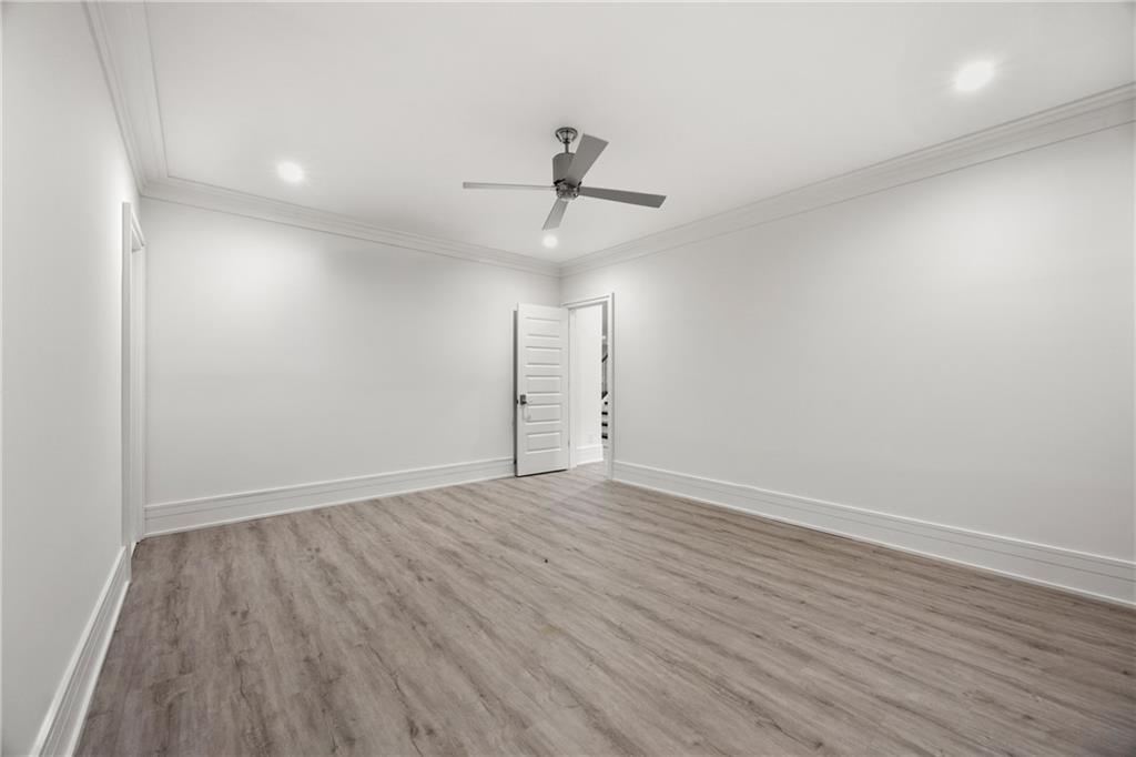 1105 Moores Mill Road Northwest Atlanta, GA 30327 - Photo 63 of 77 wooden floor in an empty room with a window