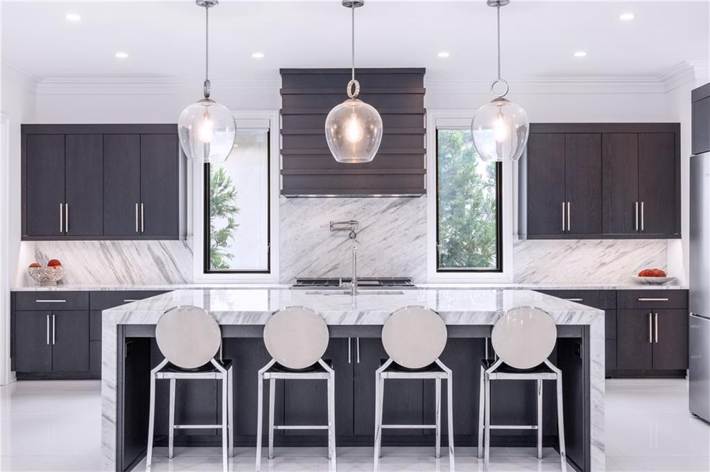 1105 Moores Mill Road Northwest Atlanta, GA 30327 - Photo 7 of 77 a kitchen with a dining table chairs and white cabinets
