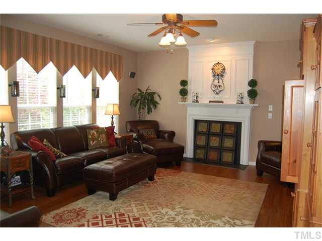 5422 Regatta Way Raleigh, NC 27613 - Photo 3 of 18 a living room with furniture a fireplace and a large window