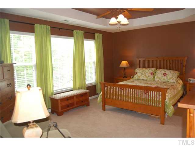 5422 Regatta Way Raleigh, NC 27613 - Photo 7 of 18 a bedroom with a bed and a window