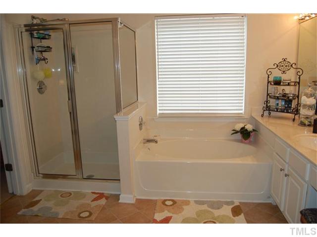 5422 Regatta Way Raleigh, NC 27613 - Photo 8 of 18 a bathroom with a bathtub and a sink