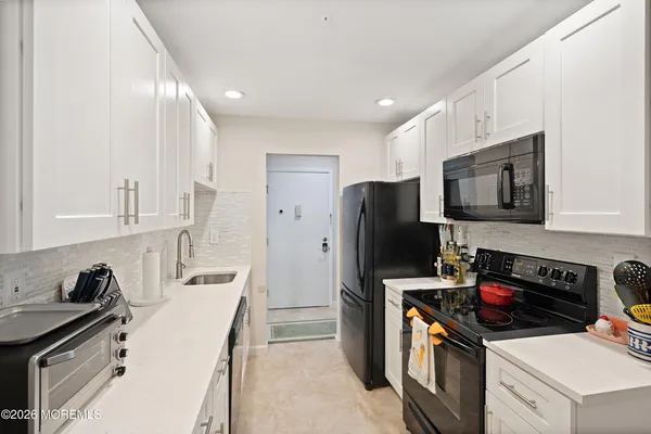 a kitchen that has a sink and a stove top oven