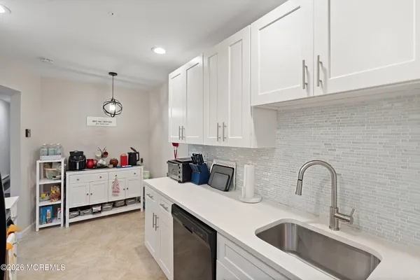 a kitchen with a sink dishwasher and cabinets