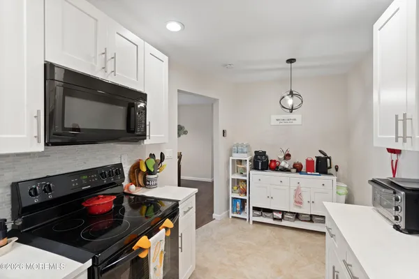 a kitchen with a stove and a microwave