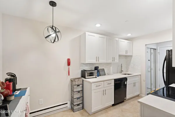 a kitchen with a sink appliances and cabinets