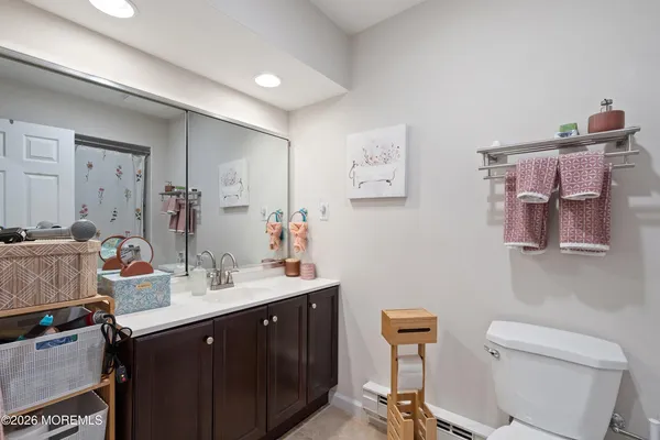 a bathroom with a toilet a sink and mirror