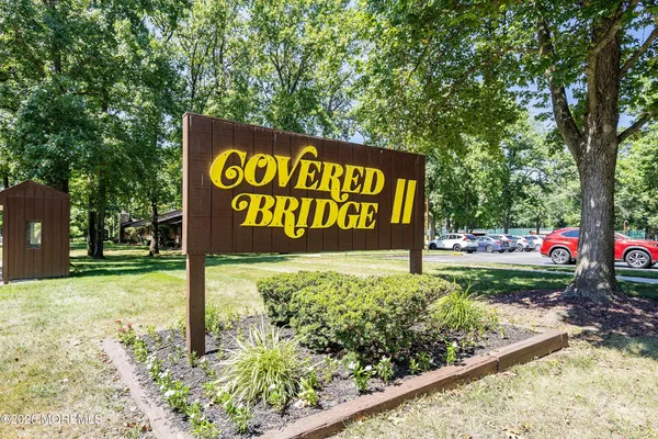 a sign broad in front of flowers