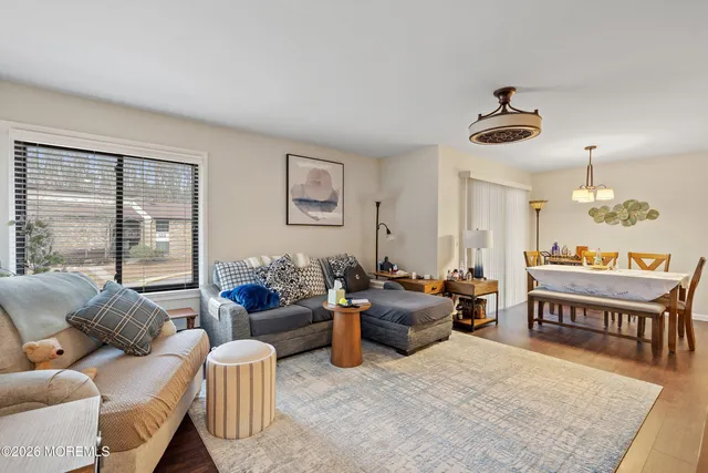 a living room with furniture dining area and a large window