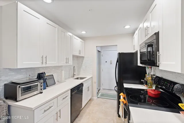 a kitchen with stainless steel appliances a refrigerator sink and microwave