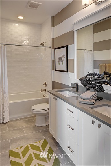 304 Field Place Southeast Renton, WA 98059 - Photo 7 of 10 a bathroom with a granite countertop sink a toilet and shower