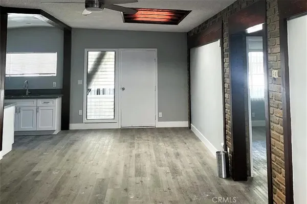 a view of a livingroom with a window and wooden floor