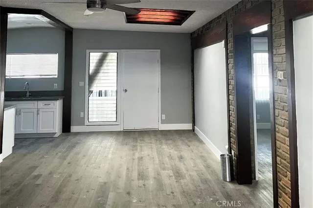 a view of a livingroom with a window and wooden floor