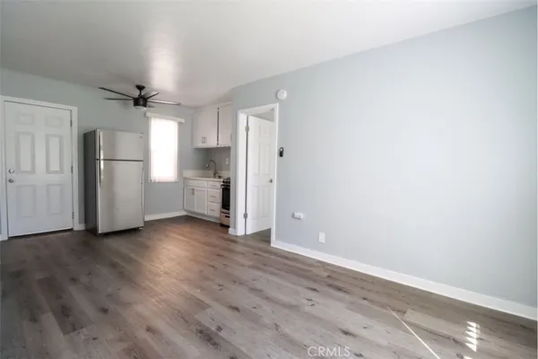 a kitchen with stainless steel appliances a refrigerator sink and cabinets