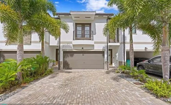 a front view of a house with a garden