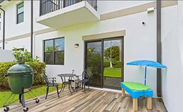 a living room with a chair and a potted plant