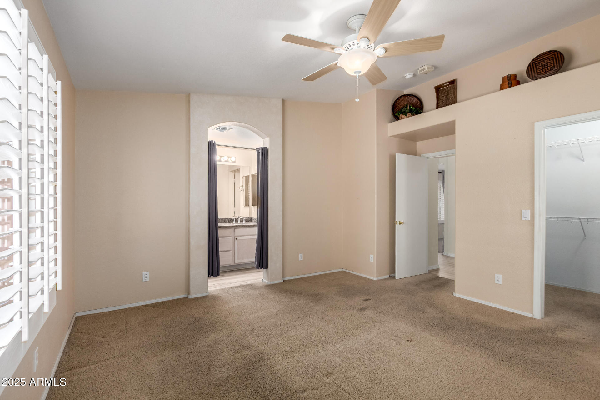 2101 South Meridian Road, Unit 301 Apache Junction, AZ 85120 - Photo 11 of 30 an empty room with closet and a chandelier fan